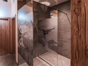 a walk in shower with a dinosaur mural on the wall at APART Naturcamping Kuprian in Längenfeld +50 photos