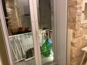 a glass door with a vase on a balcony at DaDa' Home in Trani