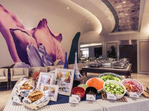 a buffet of food on a table in a room at Mercure Hangzhou West Lake in Hangzhou +41 photos