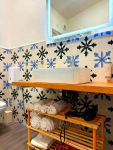 a bathroom with a sink and blue and white tiles at Il Sogno Siciliano in Mazara del Vallo +28 photos