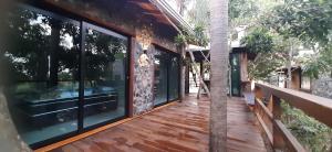 una casa con un terrazzo in legno con grandi finestre di Refúgio Sereno a Bonito