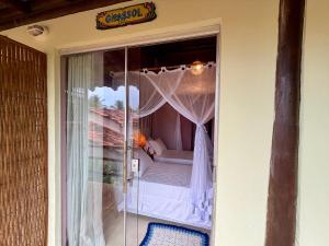 a room with a bed on a balcony at Vila BeiradeiRô - Taipu de Fora in Taipu +69 photos
