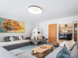 a living room with a couch and a tv at APART Naturcamping Kuprian in Längenfeld