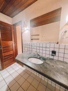 a bathroom with a sink and a mirror at Vila Bela Vista in Jijoca de Jericoacoara