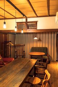 a large wooden table in a room with chairs at 隠れ古宿 おくゆかし in Beppu