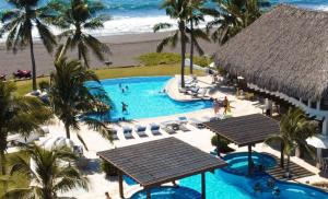 an aerial view of a swimming pool at the beach at Hotel Dos Mundos Monterrico - Pacific Resort in Taxisco