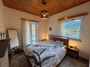 a bedroom with a bed and a large window at Kastellia Horizon Villa in Graviá