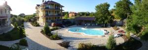 an aerial view of a swimming pool in front of a building at Mini-Dacha in Kurortne