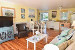 een woonkamer met een bank en een tafel bij Cottage w Private Association Pool in Wellfleet +23 foto's