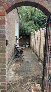 a patio with a table and a fence at Cosy- Casa in Luton