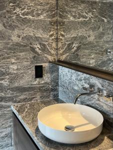 een badkamer met een wastafel en een spiegel bij Boutique New 1-Bedroom Condo in Heart of Downtown in Vancouver