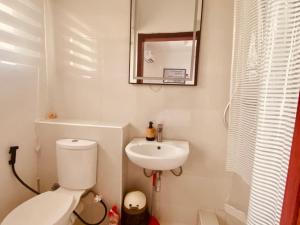 a small bathroom with a toilet and a sink at Simplistic Ambience At The Lekki Peninsula, Lagos in Mama +1 photo