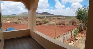a room with a window with a view of a field at Ngelenyi Homes in Voi