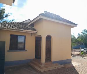 a small house with a porch at Ngelenyi Homes in Voi