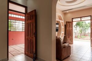 a hallway with a door and two chairs in a house at Ngelenyi Homes in Voi