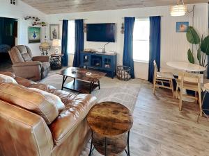 a living room with a couch and a table at Sand Piper in Rockport