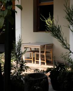 a table and chairs in a room with plants at XTILU Hotel - Adults only - in Oaxaca City