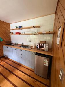 a kitchen with a sink and a stove top oven at Yelcho en la Patagonia in Chaitén +46 photos