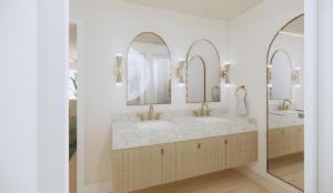 a bathroom with two sinks and two mirrors at Pavilion Hotel in Avalon