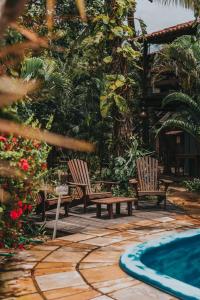 a patio with two chairs and a swimming pool at Vila Bela Vista in Jijoca de Jericoacoara