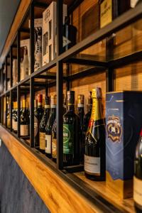 a row of bottles of wine on a shelf at Maar Hotel Brezovice in Prevallë