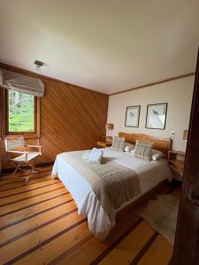 a bedroom with a large bed and a window at Yelcho en la Patagonia in Chaitén