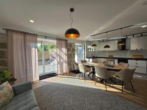 a living room and kitchen with a table and chairs at Casa Lage da Pena in Geres