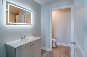 a bathroom with a sink and a toilet at Ocean Escape Boardwalk Oceanfront in Myrtle Beach +61 photos