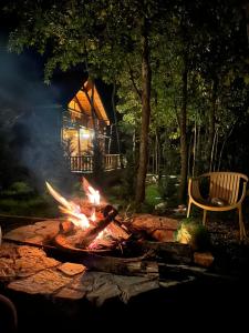 a fire pit in a yard with a house in the background at Villa n'Mal in Orllan +4 photos