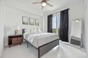 a white bedroom with a bed and a window at RIVER FLY IN The Cocoa Island Horizon View RFI 3BR KQQ City in Audubon