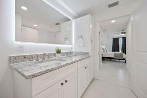 a white bathroom with a sink and a mirror at RIVER FLY IN The Cocoa Island Horizon View RFI 3BR KQQ City in Audubon