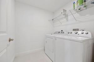 a white laundry room with a washer and dryer at RIVER FLY IN The Cocoa Island Horizon View RFI 3BR KQQ City in Audubon +23 photos