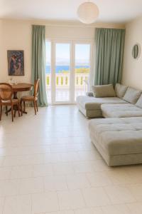 a large living room with a couch and a table at Caecilia & Lawrence Villa in Chalkida