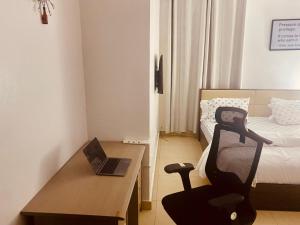 a room with a desk and a chair with a laptop at Simplistic Ambience At The Lekki Peninsula, Lagos in Mama
