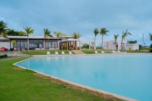 a swimming pool in front of a house at Casa Luma Vistacana in Pueblo Bavaro