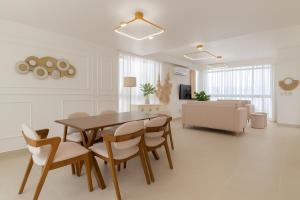 a living room with a table and chairs and a couch at Casa Luma Vistacana in Pueblo Bavaro