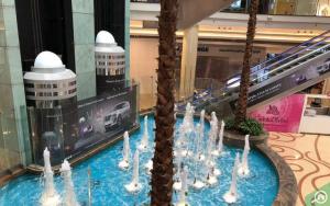 a water feature in a mall with a fountain at Luxuries Private Room In a Home In Front of Mega Mall Sharjah in Sharjah