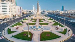 a large plaza with a fountain in the middle of a city at Luxuries Private Room In a Home In Front of Mega Mall Sharjah in Sharjah