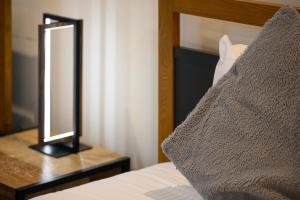 a mirror sitting on a table next to a bed at The Victoria Inn in Truro