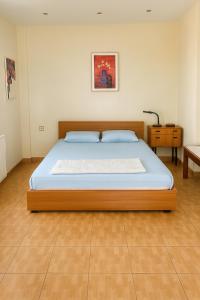 a bedroom with a wooden bed with a blue mattress at Caecilia & Lawrence Organic Mediterranean Sea Villa in Chalkida +22 photos