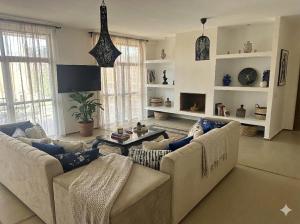 a living room with two couches and a table at Villa Léa in Marrakesh