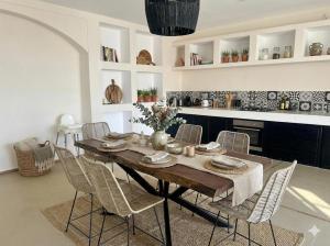a dining room with a wooden table and chairs at Villa Léa in Marrakesh