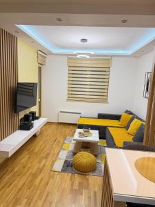 a living room with a couch and a table at Prestige Forest Resort Zlatibor Wellness & Spa in Zlatibor +66 photos