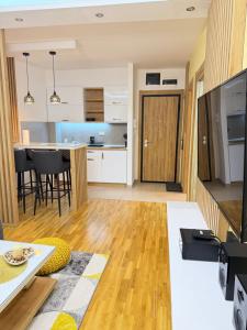 an open living room with a kitchen and a dining room at Prestige Forest Resort Zlatibor Wellness & Spa in Zlatibor