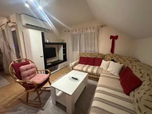 a living room with a couch and a table at Stan Travnik in Travnik