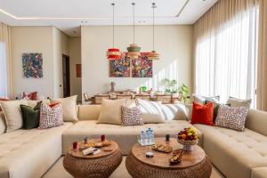 a living room with a couch and two tables at Berber Garden in Aït Amara