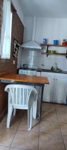 a kitchen with a table and a bench in it at Lo de Vlady in Mina Clavero