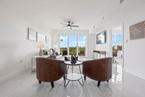 Luxury River Front Secluded Condo w Resort Amenities RFI 909 في Audubon: غرفة معيشة مع كرسيين وطاولة