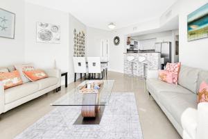 a living room with a couch and a table at Luxurious 2BD Condo with Direct Ocean Views & Resort Pool in Sunny Isles in Sunny Isles Beach