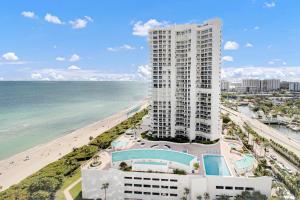 an aerial view of a building and the beach at Luxurious 2BD Condo with Direct Ocean Views & Resort Pool in Sunny Isles in Sunny Isles Beach